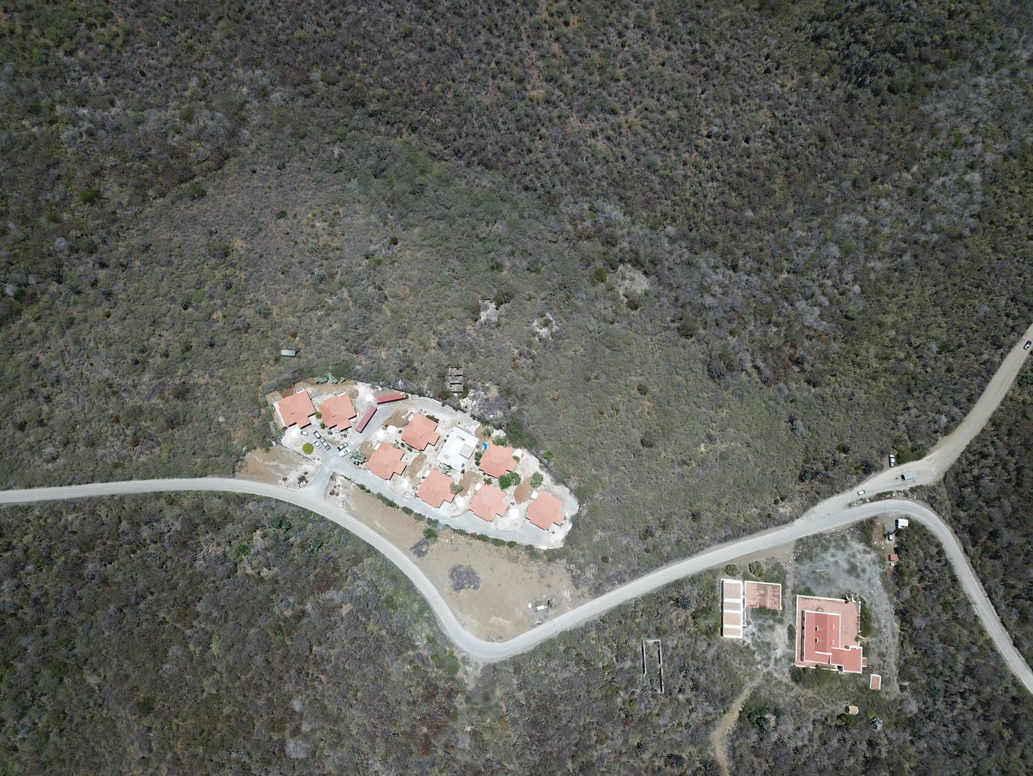 The resort from directly above, eight roofs around the central pool