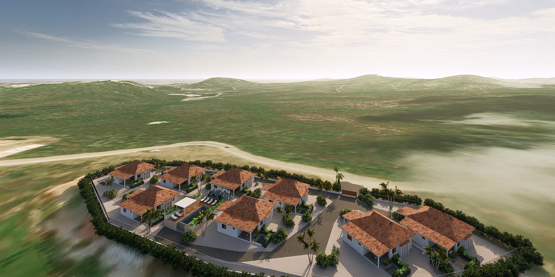 Aerial view of the resort in the landscape, villas set around an oval drive